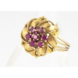 A continental yellow metal 18k ruby cluster ring, leaf design, with beaded decoration and banded