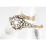 An 18ct yellow gold and platinum diamond solitaire, the illusion set diamond in raised claw setting,