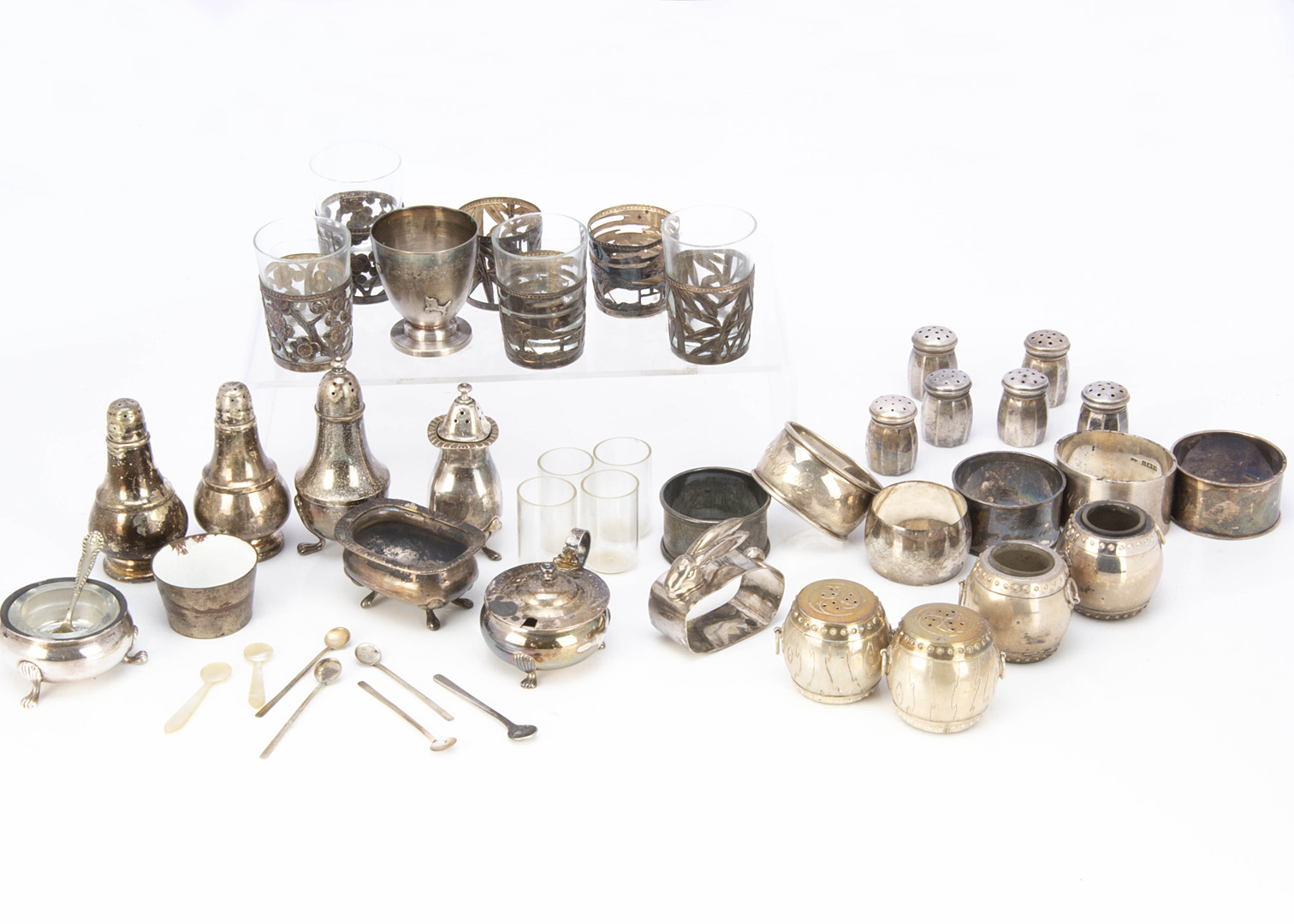 A collection of silver and white metal cruet items and napkin rings, along with other small items