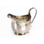 A George III silver milk jug by Crispin Fuller, 10.5cm high, 3.58 ozt, repaired to handle, helmet