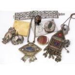 A collection of silver and white metal jewels, including an oval nephrite locket, a paste pendant,
