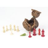 A 19th century walnut case, hinged front quarter and containing a miniature part carved bone chess