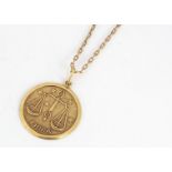 A continental yellow metal Libra pendant and chain, circular medallion marked to reverse, 18k 750,