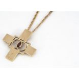 A contemporary 9ct gold and garnet cross pendant, centred with a marquise cut garnet, marked to