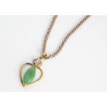 A continental jadeite jade and white sapphire pendant, on a 9ct gold flattened curb linked necklace,