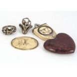 Four erotic jewels, including two white metal rings of lovers paying each other intimate