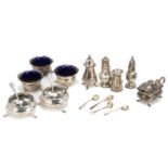 A small group of silver cruet items, including a pair of Victorian cauldron salts, four pepper pots,