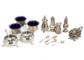 A small group of silver cruet items, including a pair of Victorian cauldron salts, four pepper pots,