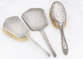 An Art Deco period silver hand mirror and hair brush, together with a dented silver hair brush (3)