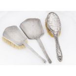 An Art Deco period silver hand mirror and hair brush, together with a dented silver hair brush (3)