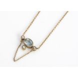 A 15ct gold aquamarine and seed pearl necklace, mixed oval cut aqua, surrounded by three seed