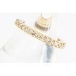 A yellow metal and diamond full eternity ring, claw set brilliant cuts, each approx 0.02cts,