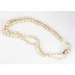 A double row of graduated cultured pearls, knotted strung united by a 14k marked clasp, 9.9mm