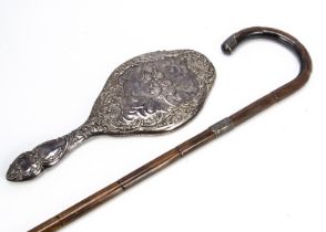 An Edwardian silver hand mirror and a later silver mounted walking stick