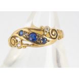 An Edward VII 18ct gold sapphire and diamond three stone ring, the three sapphires, with scroll