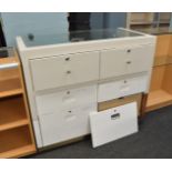 A counter top display cabinet, having two banks of three drawers to rear, plinth base, 120cm x