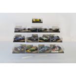 Thirteen Onyx Formula 1 1/24 scale diecast models, all contained in plastic display cases.