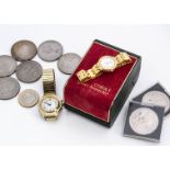 A collection of coins and watches, including two American Liberty Head dollars, a 2006 £2 coin,