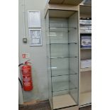 A narrow open display cabinet, having five glass shelf interior om plinth base, 49cm x 44cm x