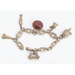 A 9ct gold flattened knot linked charm bracelet, with snap clasp, supporting six charms including an
