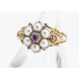 A 19th Century posy ring, centred with a cushion cut ruby surrounded by six half cut pearls, on an