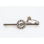An Edwardian 15ct gold aquamarine and seed pearl bar brooch, with central wreath, half cut pearls