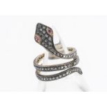 An Indian silver and silver gilt diamond and ruby serpent ring, size L, 4.2g