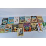 A collection of vintage children's books, including Herge The Adventures of Tintin, Walt Disney