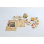 A collection of paper collectables, including three card pictures with stamp cut outs, a small