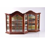 Four very well presented wall hanging wood and glass Display cabinets with canted sides each with