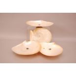Three mother of pearl shells on stands, each with silver plated octagonal stand, together with a