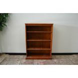 A second half 20th century yew wood bookcase, 90cm wide and 31cm deep and 123cm high, with three