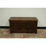 A 20th century carved oak coffer, 98cm wide and 45cm deep and 50cm high