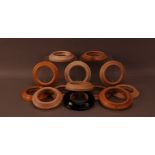 A group of wooden pot lids frames/mounts, including one ebonised example (13)