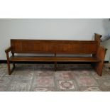 An Edwardian period oak and pine church pew, 200cm wide, with bible rest shelf to rear, possibly cut