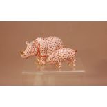 A Herend porcelain Rhinoceros, 13cm long, with a gilt horn, together with a pig. 8cm long both