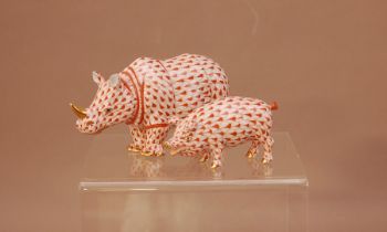 A Herend porcelain Rhinoceros, 13cm long, with a gilt horn, together with a pig. 8cm long both