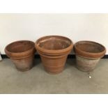 Three large modern terracotta garden pots, largest 60cm diameter and 54cm high, AF (3)