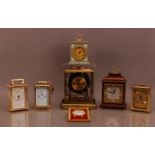 A collection of clocks, comprising four carriage clocks, a Wedgwood mantle clock, a larger mantle
