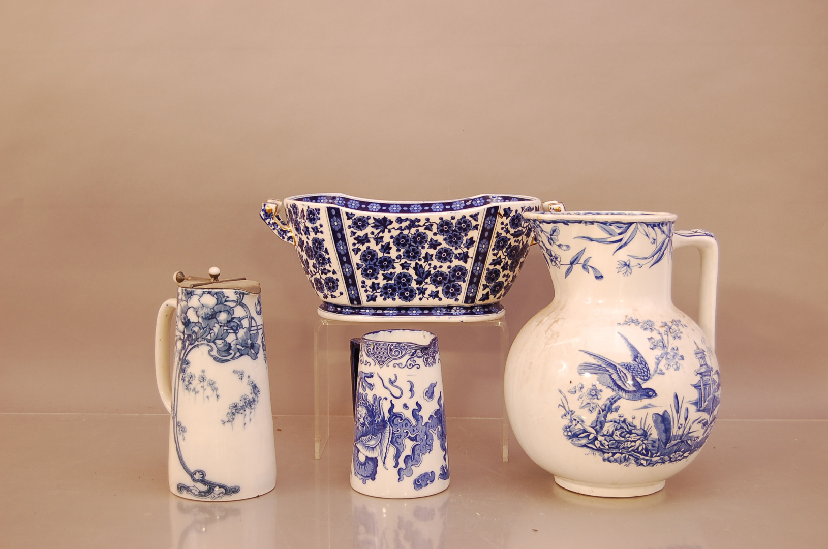 A group of 19th century blue and white ceramic items, comprising, a large water jug with bird design