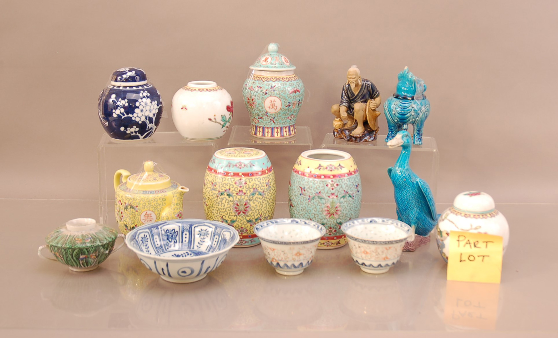 A large collection of Oriental ceramics, including tea pots, ginger jars (some missing lids), cups