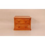 A late Victorian mahogany apprentice chest of draws, the top with a moulded edge, two graduated