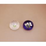 Two 20th century Baccarat paperweights, both with flower design and marked to the underside, one no.