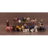 A collection of ceramic Cow Parade cows, comprising an assortment of cows, some American related