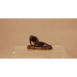 A Victorian bronze of a slave, 11cm wide oval base, with nude figure of a man resting