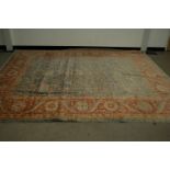 A second half 20th century Pakistan woollen carpet, 300cm by 249cm, faded and stained