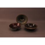 Three contemporary studio pottery bowls, comprising a green and gilt decorated footed bowl by