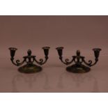 A pair of art deco bronze Danish two branch candelabra's, in the style of Just Anderson, the paint