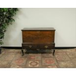 A Georgian and later oak chest on stand, the chest raised on a base with two frieze draws on