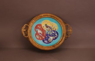 A late 19th century French Majolica ceramic dish with bird decoration, in a gilt metal mount with